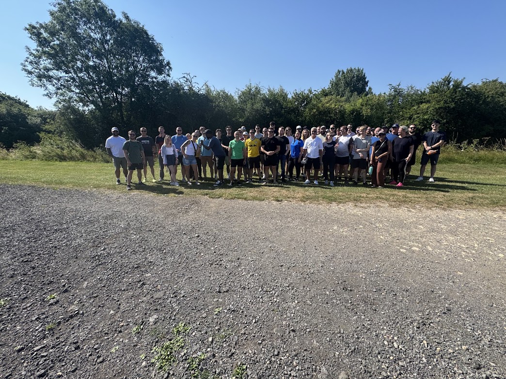 Large corporate team building group at Yorkshire Activity Centre on a sunny day